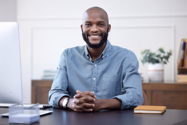 happy-desk-portrait-black-man-entrepreneur-corporate-company-agency-office-arms-crossed-professional-african-young-person-employee-ready-business-development-with-smile_590464-183502.avif